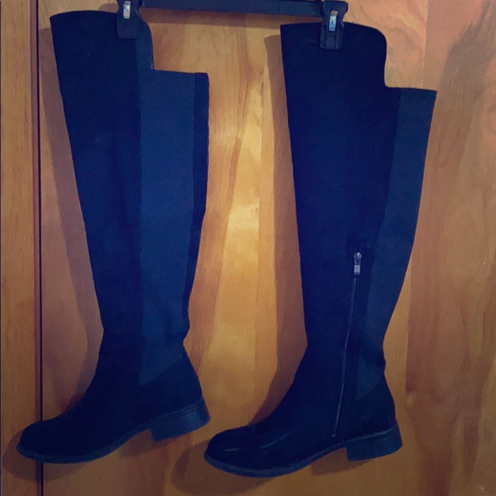 Over the knee black boots.